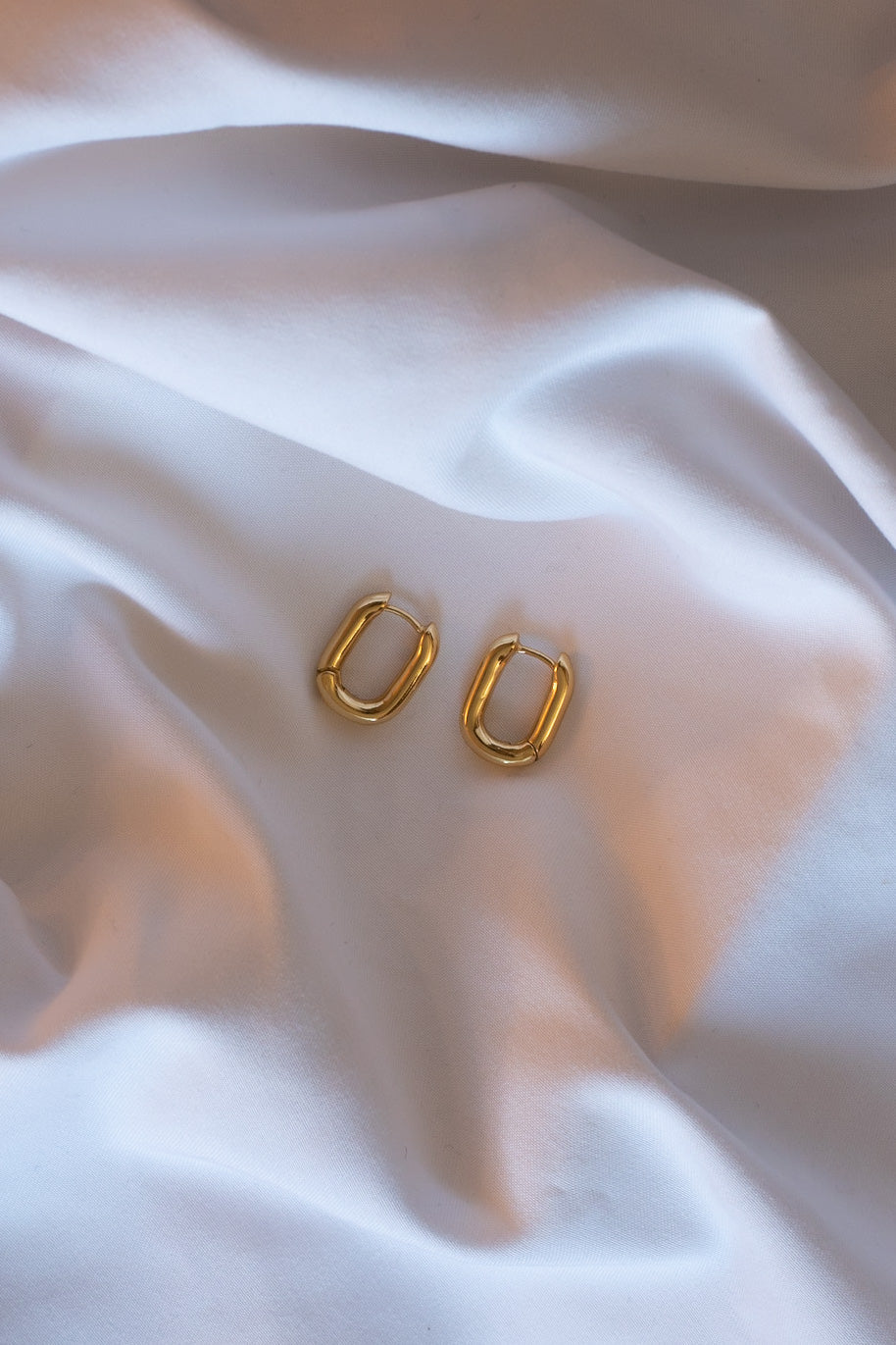 golden huggie hoops - earrings